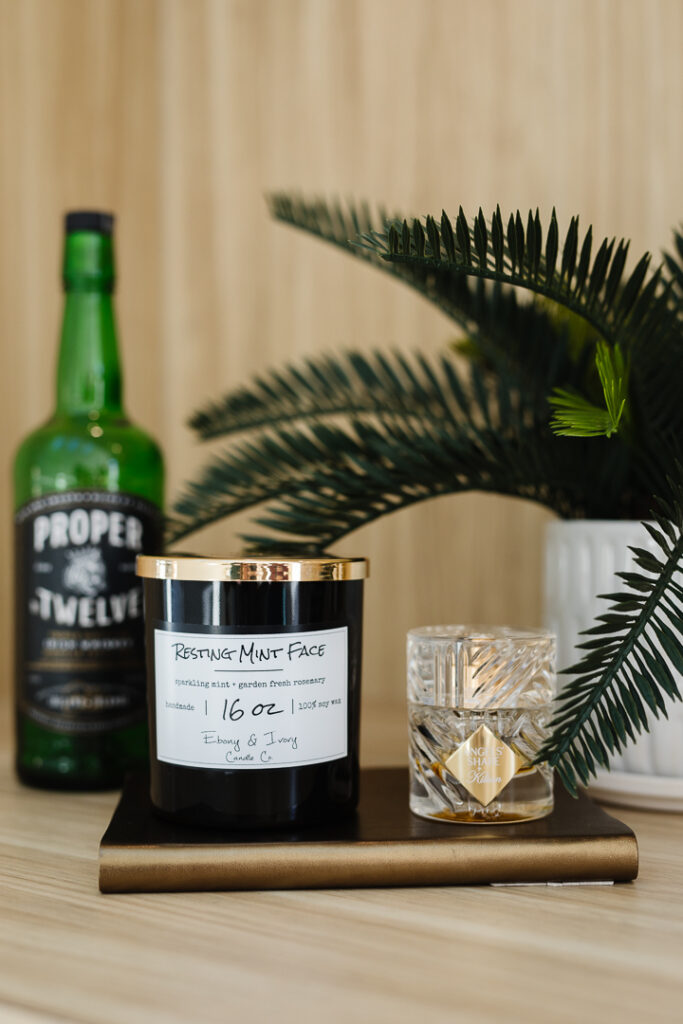 Candle next to a drink on a tray - styled Lethbridge product photos