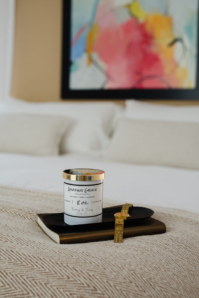 Candle sitting on a book on a bed