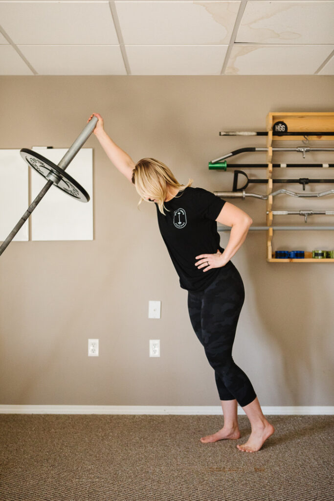 Woman lifting bar with weight