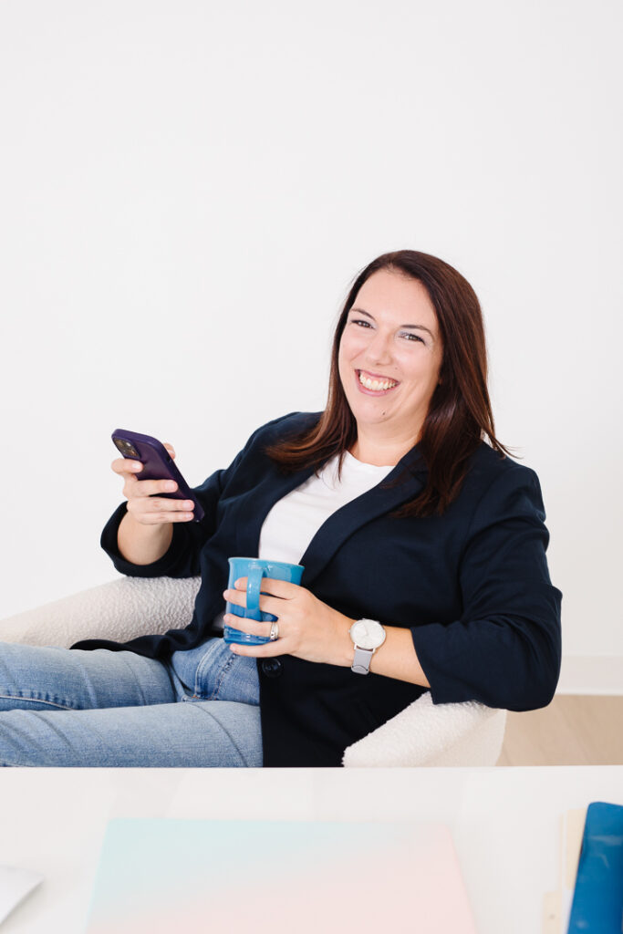 Woman with phone in one hand and coffee mug in other hand. Virtual Assistant Brand Photos Lethbridge Alberta