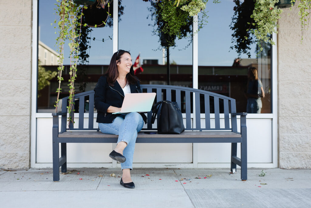 Woman sitting on bench in front of store. Virtual assistant brand photography